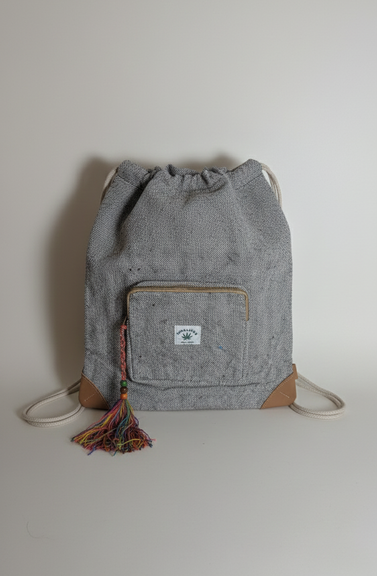 Gray drawstring bag with a small patch on a light gray background