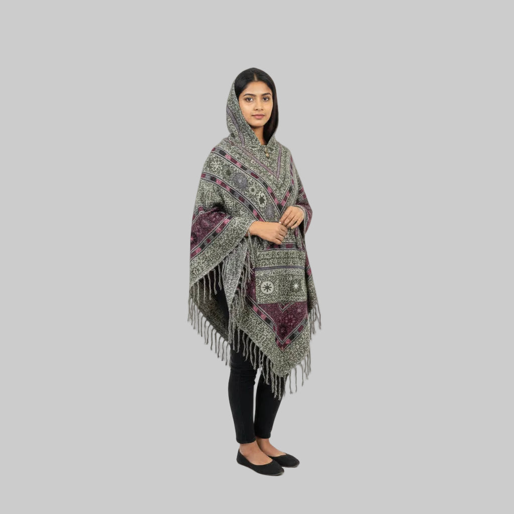 Woman wearing a patterned poncho on a white background