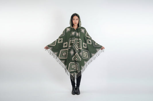 Woman wearing a green patterned poncho on a white background