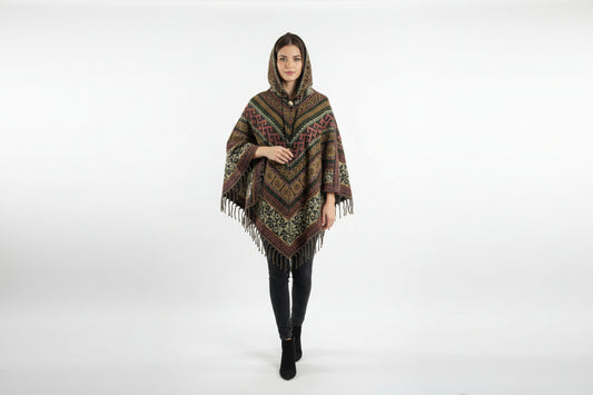 Woman wearing a patterned poncho with fringes on a white background