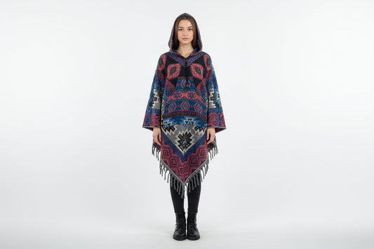 Woman wearing a patterned poncho on a white background