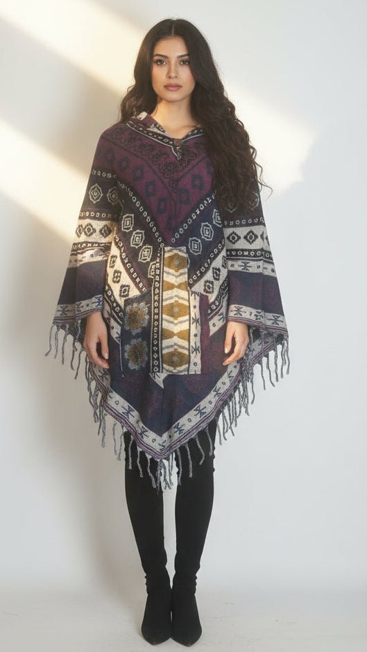 Patterned shawl with fringes on a wooden hanger against a white background