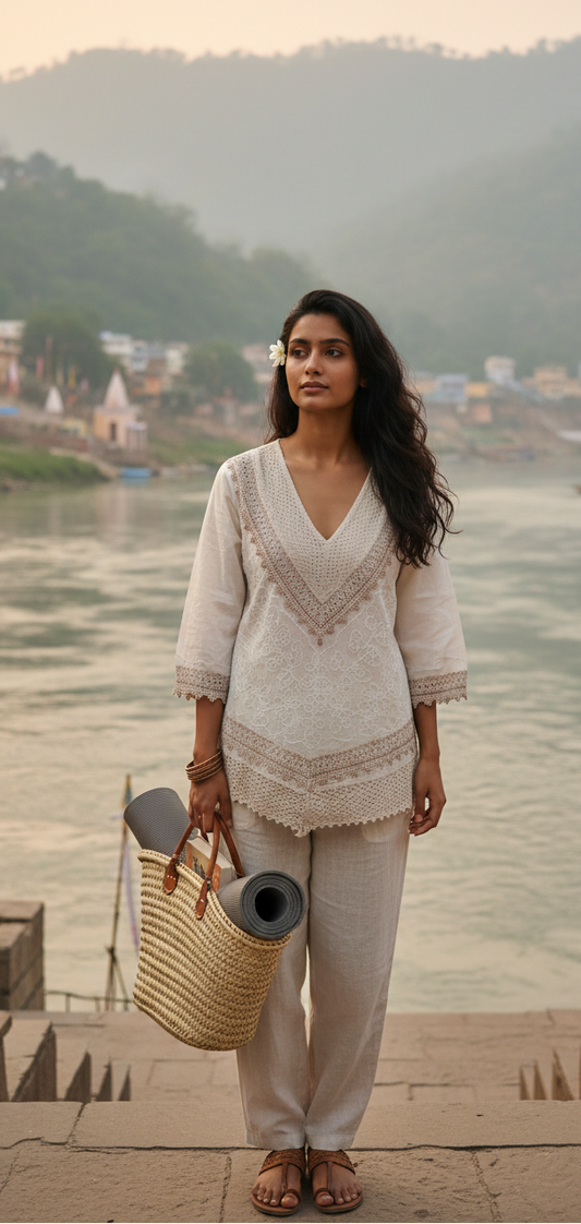 Woman standing by a river with mountains in the background